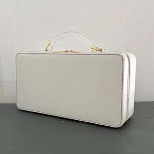 Estée Lauder white train case with lucite handle